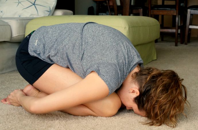 Modified child's pose to release a tight lower back