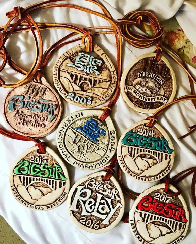 A group of Big Sur medals on a bed.